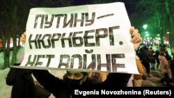 Протестующий с антивоенным баннером в день вторжения России в Украину. Иллюстративное фото