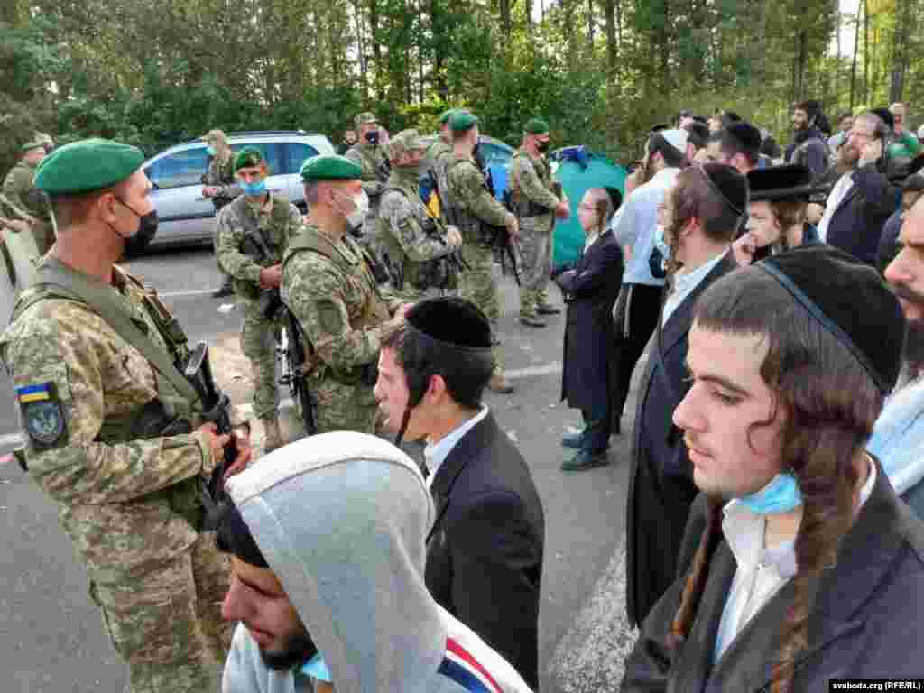 Ukrainian border guards keep an eye on Hasidic pilgrims.