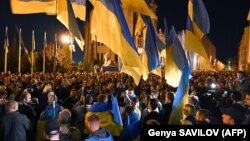 People take part in a protest against the approval of the so-called Steinmeier Formula in front of the president's office in Kyiv on October 2.