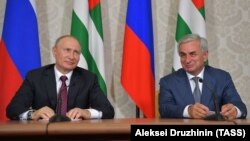 Russian President Vladimir Putin (left) meets with Raul Khajimba, the leader of Georgia's breakaway region of Abkhazia, on August 8.