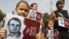 Protesters outside the Russian Embassy in Kyiv hold banners calling for Moscow to release Oleh Sentsov.