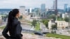 A file photo of a young woman looking out over Vilnius, Lithuania. 