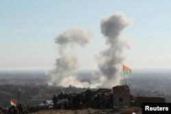 Smoke rises from the site of U.S.-led air strikes in the town of Sinjar, November 13, 2015