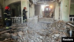 Emergency personnel work in a hotel building hit by a Russian missile strike in Kryviy Rih, Dnipropetrovsk region, Ukraine, on March 6.