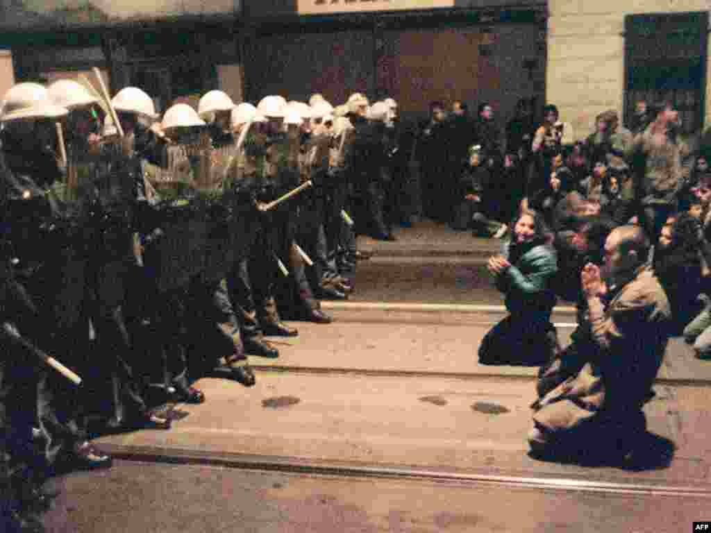 Protesters kneel as they face riot police on November 19. The authorities again responded with violence.