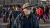 CHINA -- People wearing protective masks arrive at Beijing railway station to head home for the Lunar New Year, January 21, 2020