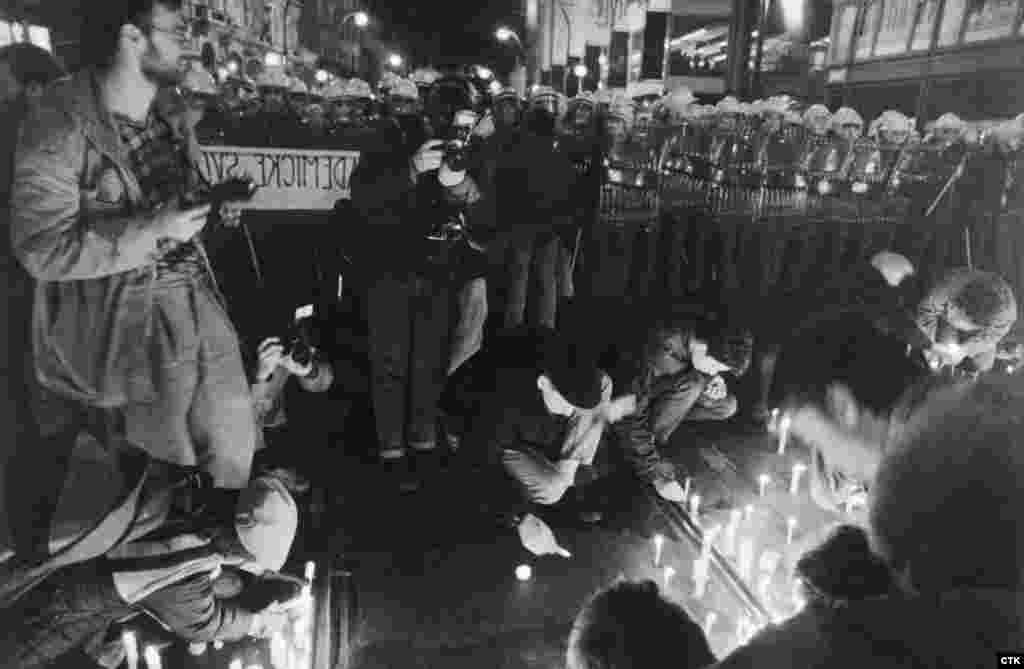 Students light candles near a police cordon. Although the protests were nonviolent and students chanted &quot;We have bare hands&quot; to tell authorities that they were unarmed, riot police sealed off escape routes and attacked them. &nbsp;