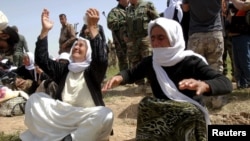 Members of the Yazidi minority sect who had been held by Islamic State after their release, near the Iraqi city of Kirkuk, on April 8, 2015