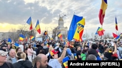 People gather in front of the Constitutional Court in Bucharest as it hears the appeal of far-right politician Calin Georgescu over the rejection of his candidacy in a May presidential election.