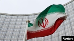 An Iranian flag flutters in front of the International Atomic Energy Agency's headquarters in Vienna. (file photo)