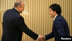 Georgian President Giorgi Margvelashvili (left) congratulates newly elected parliament speaker Irakli Kobakhidze during the first session of the parliament in Kutaisi in November 2016.