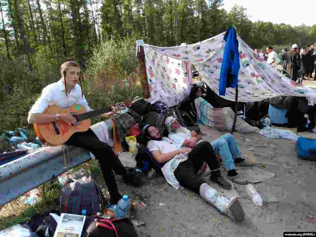 A Jewish pilgrim playing guitar to pass the time.