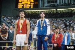 Silver medalist Serik Konakbaev (left) of the U.S.S.R. and gold medalist Patrizio Oliva of Italy during the awards ceremony for the men's light welterweight division at the 1980 Summer Olympics in Moscow.