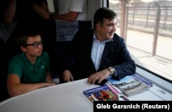 Former Georgian president and ex-Odesa Governor Mikheil Saakashvili and his son Nikoloz sit in a train at a Polish railway station as they prepare to head for the Ukrainian border on September 10.