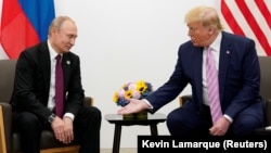 US President Donald Trump gestures during a meeting with Russian President Vladimir Putin at a G20 leaders summit in June 2019.