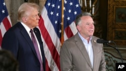 President-elect Donald Trump listens as Steve Witkoff speaks during a news conference at Mar-a-Lago, Tuesday, Jan. 7, 2025, in Palm Beach, Fla. 