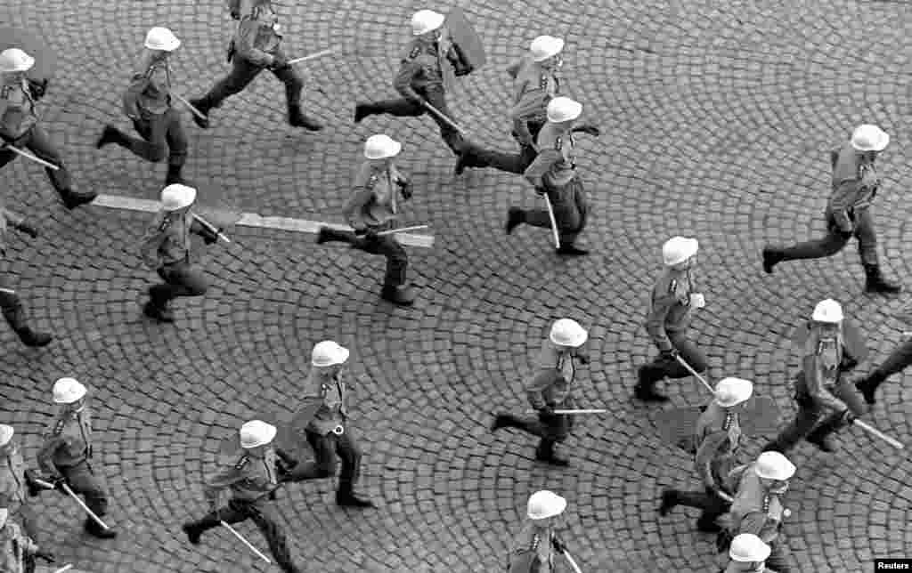 Police race after protesters who had gathered to mark the anniversary of the 1968 Soviet-led invasion on August 21.&nbsp;The first cracks were appearing in communist rule.